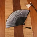 Classic folding bamboo fan with black cherry blossom pattern and silk tassel ornament - Falling Petals