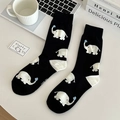 Detail of black cotton socks featuring cute white elephant pattern in cozy desk setting - One Size / Black
