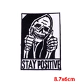 Detail of Stay Positive skull embroidery patch with thumbs up for denim jacket DIY - Skull Stay Positive