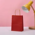Minimalist red kraft paper gift bag with durable twisted handles for premium packaging - Dark Red / 21*15*8