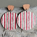 Macro shot of striped wooden drop earrings in festive red, white, and green on grey stone - Red White Green Striped