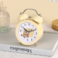 Detail of yellow metal twin bell alarm clock with a cute cartoon capybara on white dial - 06 Yellow