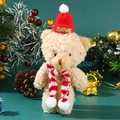 Close-up of beige plush bear with red LOVE hat and striped scarf in Christmas setting - 15-18cm / Blush Brown Bear + Red Hat Red White Scarf