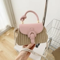 Pink woven straw handbag with a leather flap and knot design on the top handle - Pink