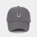 Close-up of deep gray twill cotton baseball cap with white embroidered smiley face design - Adjustable / Gray