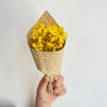 Close-up of mini yellow dried flowers bouquet in vintage newspaper wrap with jute twine - Vintage Mini Yellow Gypsophila