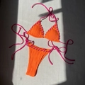 Orange ribbed bikini set with pink criss-cross side ties on a sunny white background - S / Orange Red