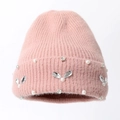 Primo piano di un berretto in maglia rosa con strass a forma di coniglio e perle - Taglia unica / Rosa Antico