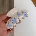 Detailed close-up of beige acetate hair claw clip with blue flowers and gold beads - Beige Butterfly