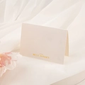 Folded white textured card with golden Best Wishes text on white gauze with flowers - Best Wishes White (Gold Stamping)