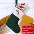 Green knitted Christmas stocking with white cuff and red embroidered letter S detail - Letter S / Dark Green