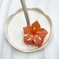 Translucent orange plumeria flower hair claw clip in resin on white tray - Red (Five-petal Flower)
