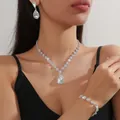 Detail of 3-piece silver jewelry set with water-drop white crystals on elegant model - White