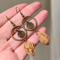 2511173b Hollowed-out Circular Fruit Pit Pendant