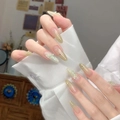 Detail of long ballerina nails with green gradient and 3D white butterfly wings - By1567 Is Lush And Vibrant. / Glue Type