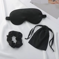 Three-piece black faux silk sleep set including eye mask, scrunchie and drawstring bag - Black