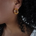 Irregular gold geometric earrings with clear zircon stones worn by a model - Gold
