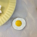 Handmade ceramic fried egg refrigerator magnet with glossy finish on white paper - Fried Egg