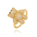 Makroaufnahme eines goldenen Bärenrings mit funkelnden klaren und schwarzen Steinen - Einstellbar Offen / Gold/Weißer Zirkonia