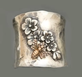 Detailed macro view of vintage silver wide band ring with embossed flowers and golden bee - US 6 / Bee Flower Relief Style (KYRA01489)