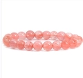 Single-strand pink translucent beaded bracelet with round gemstone beads on white background - Watermelon red