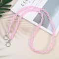 Pink double-strand braided phone crossbody strap with silver metal buckles on beige background - Pink