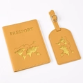 Detail view of yellow PU leather passport holder and luggage tag with gold world map embossing - Ginger Yellow Map
