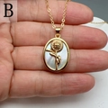 Macro detail of oval mother of pearl necklace pendant with 3D gold sunflower relief - Style B