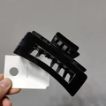 Close-up of large black geometric shark hair claw clip made of high-gloss acrylic material - Black