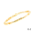 Macro detail of natural carnelian beaded bracelet with gold plated spacers and lobster clasp - Orange Chalcedony Snowflake Plate