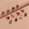 Macro shot of colorful round birthstone charms with stainless steel edges for DIY jewelry making - Multicolor