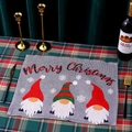 Close-up of gray knitted Christmas placemat featuring a gnome and Merry Christmas text - Style A