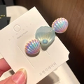 Detail view of a Korean mermaid style hair clip with iridescent shells and a center pearl - 6* Mermaid Pearl Shell - Blue