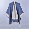 Detail view of two-tone blue and grey split poncho cape with soft knitted texture - Navy/Grey