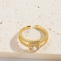 Minimalist double-band gold ring with circular zircon center stone and pave accents - Round White Zirconia