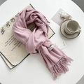 Pink cashmere feel knit scarf with fringe tassels shown in a cozy home setting - Baby Pink