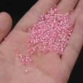 Pink glass silver-lined seed beads for DIY jewelry making displayed in hand - 3mm / 15g / Light Pink