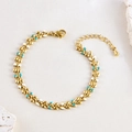 Detail of bohemian gold bracelet with blue and white enamel wheat leaves and lobster clasp - Blue White