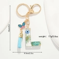 Detail of floral resin letter L keychain with blue butterfly and size specs shown - Letter L