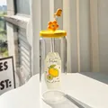 Clear glass water bottle with yellow lid, straw, and lemon stickers in natural light - Lemon + Lid + Straw + Dust Cap