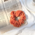 Elegant orange velvet scrunchie hair tie for women with a soft glossy texture - Orange