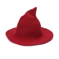 Close-up detail of dark red knitted pointed witch hat showing thick yarn texture - Burgundy