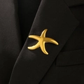 Detail of high-polish gold starfish lapel pin on a black textured suit blazer collar - Glossy Starfish Style (02 Titanium Gold 6218)