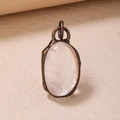 Vintage bronze pendant with oval rose quartz stone on a textured beige background - White Crystal