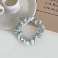 Elegant light blue satin scrunchie with silky luster on a decorative ceramic dish - Silver Gray