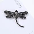 Macro shot of luxury dragonfly brooch with dark grey rhinestones and silver metal - 9.1*7cm / Gray