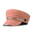 Detail of a bright orange-pink newsboy cap with silver chain decoration and black buttons - Orange