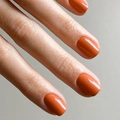 Glossy vibrant pumpkin orange short square press-on nails shown on hand model - Orange Red (JP3163)