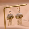 Baroque pearl fringe drop earrings with gold chains and crystals on a display stand - Flat Pearl Tassel Earrings