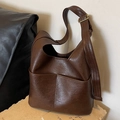 Minimalist deep brown faux leather bucket bag with large pockets and adjustable strap - Coffee